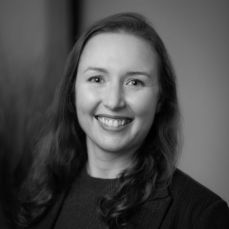 Erin Greene's headshot in black and white in office space.