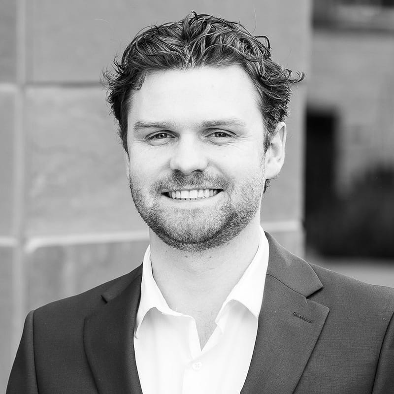 Luke Mino's headshot in black and white.