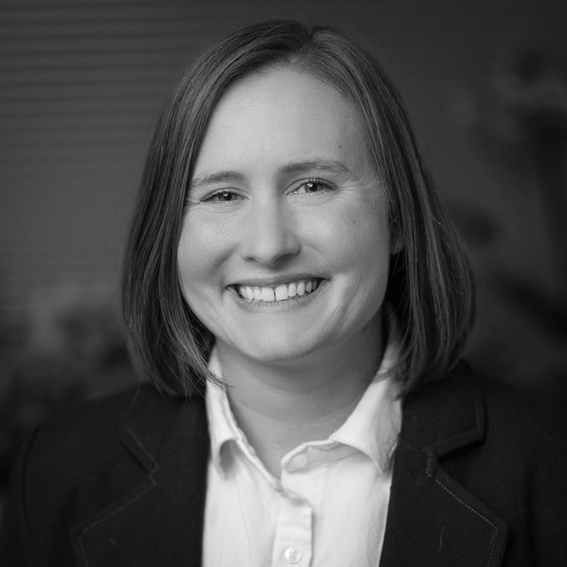 Jessica Guenther's headshot in black and white in office space.