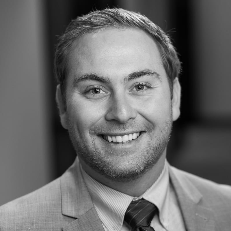 Matt Gross's headshot in black and white in office space.