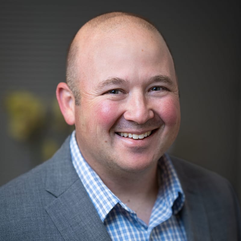 Josh Axelrod's headshot in office space.