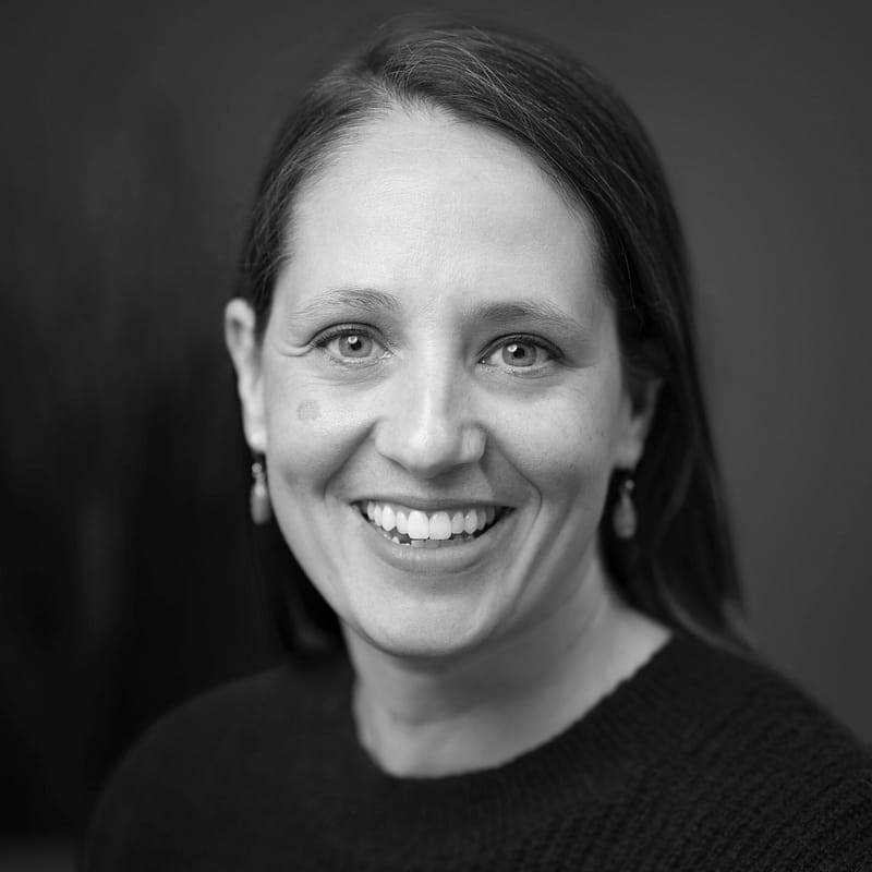 Jenny Dodge's headshot in office space in black and white.