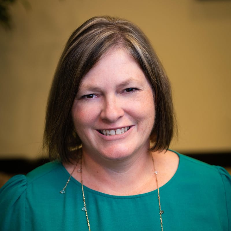 Tracy Allen's headshot in office space.