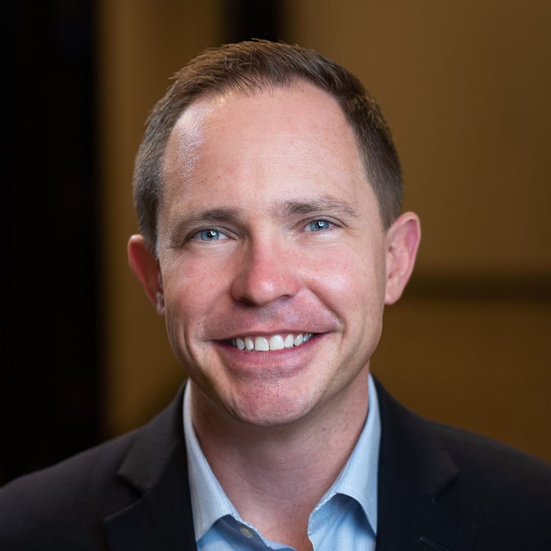 Aldrich CEO, John Lauseng's headshot in office space.