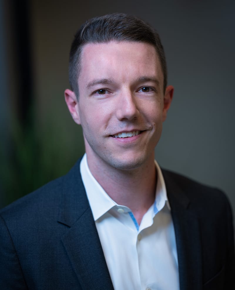 Andrew White's headshot in office space.