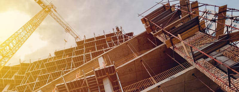 Building construction site with scaffolding, low angle view