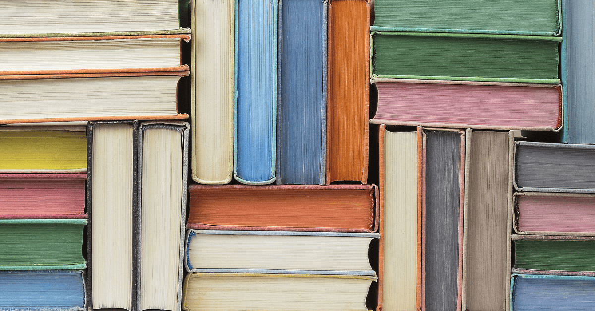 Books stacked in different different directions and colors