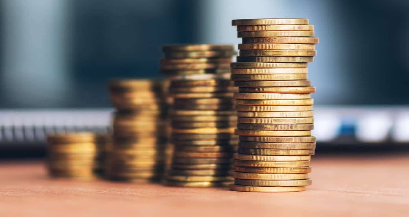 Coin stack on office desk, close up with selective focus