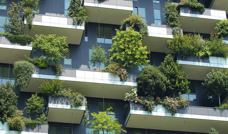 Apartment housing decks with many green trees and plants