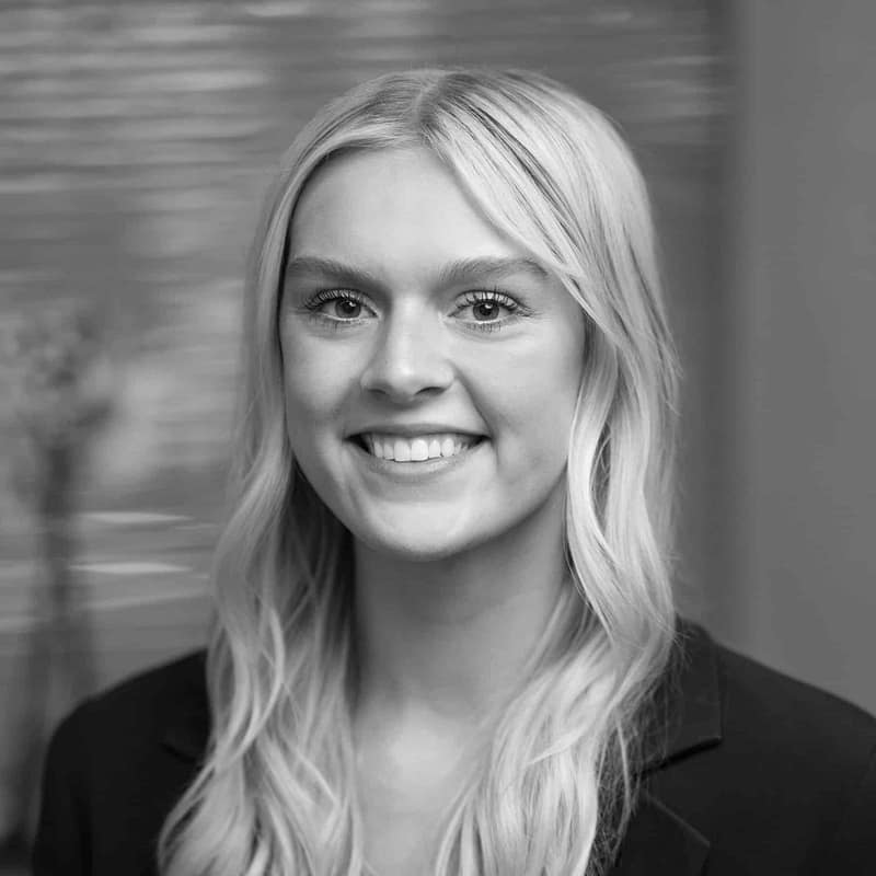 Maddy Morley's headshot in black and white in office space.